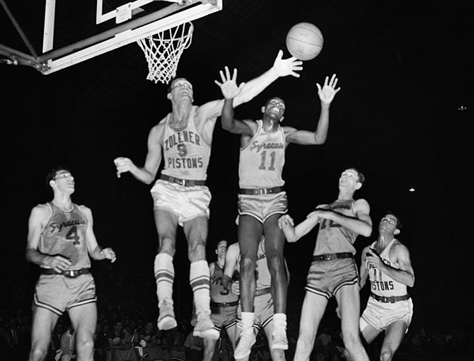 Playing for the Syracuse Nationals, Earl Lloyd (11), battles Fort Wayne’s Mel Hutchins (9) for a rebound during an NBA championship game on April 5, 1955. With the series victory, Lloyd and teammate Jim Tucker became the first African Americans to become NBA champions.
