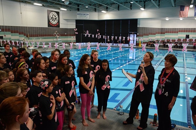 Shark Tank coach Patty Friedman (right) and breast cancer patient Ann-Marie Boland speak to swimmers before the start of the team’s fifth annual Breast Cancer Swim Marathon.
