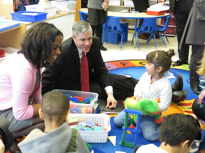 Patrick Henry Principal Ingrid Bynum (left) and Secretary of Education Arne Duncan (middle) observe pre-k students at work