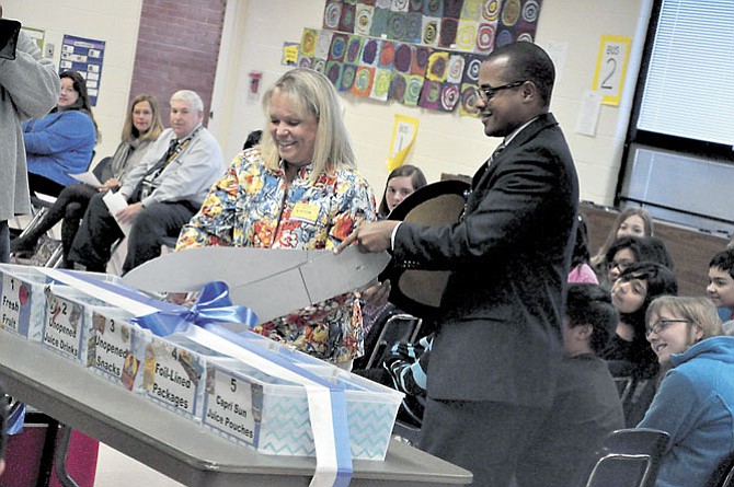 Lisa Lombardozzi, president of LINK, pictured here with Marty Smith, Cluster One assistant superintendent for Fairfax County Public Schools, on March 12, 2012, as they cut the ribbon on the new food donation bins at Dranesville Elementary School.