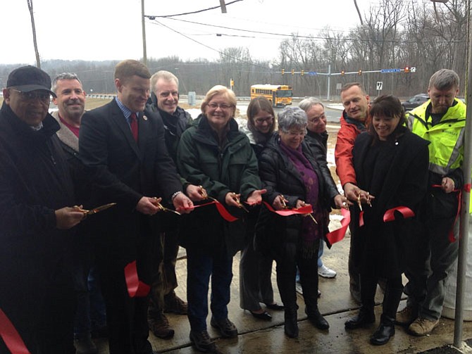 (From left) Ed Batten, Fairfax County Park Authority Board of Directors; David Lawlor with Fairfax County Park Authority; Supervisor Jeff McKay (D-Lee); Kevin Munroe, Huntley Meadows Park manager, Catherine Ledec, chairwoman of the Friends of Huntley Meadows Park; Michelle Roberts, Virginia Department of Transportation contractor; Jane Rosenbaum, senior transportation planner with Fairfax County Department of Transportation; Bill McGeehan of Alexandria; Charles Smith of Fairfax County Department of Public Works and Environmental Services; Cynthia McNeal with the Fairfax County Park Authority and Tom O’Brien, Shirley Construction manager cut the ribbon marking the completion of the Telegraph Road widening project.