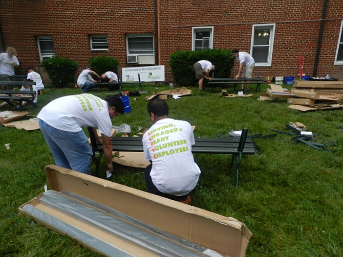 Volunteers build park benches.