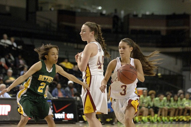 Oakton junior Alex Marquis dribbles around a pick set by teammate Delaney Connolly (44) during the Cougars’ state semifinal loss to Bethel.