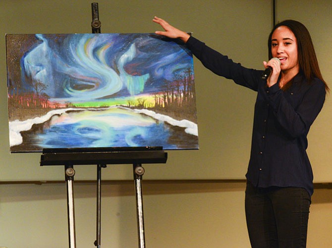 Kiana Cauley of Arlington, explaining her original artwork done in tempura and oil titled "Northern Lights."