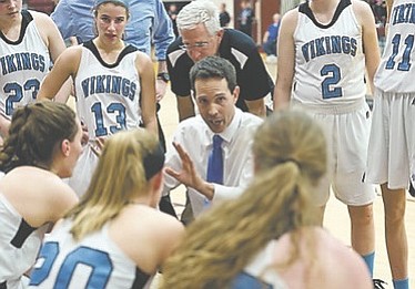 Whitman girls’ basketball coach Pete Kenah instructs the Vikings during their win over Wootton in the 4A West region championship game on March 9.