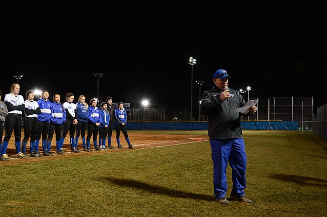 West Potomac High School softball coach Craig Maniglia (right) explains how the team plans to honor the late Hannah Graham, a former captain and outfielder.