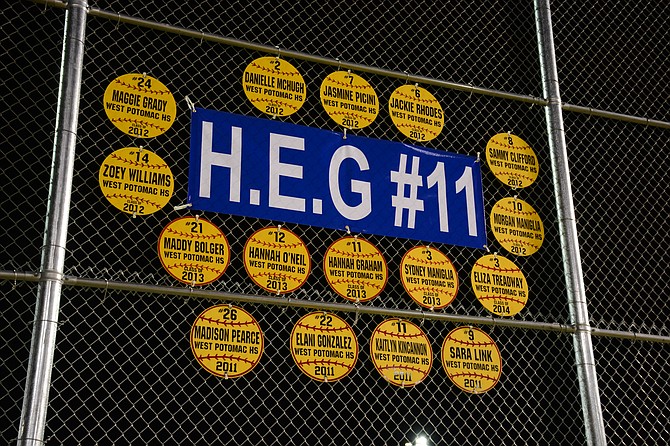 The fence looking over right field at the West Potomac softball park honors Hannah Graham prominently, along with softball placards for other Wolverine alumni.
