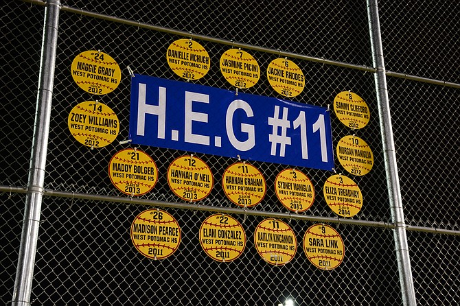 The fence looking over right field at the West Potomac softball park honors Hannah Graham prominently, along with softball placards for other Wolverine alumni.
