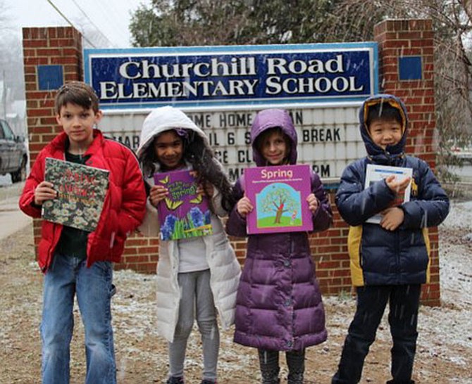 On the first day of Spring, Churchill Road second graders Caleb Wolford, Jina Ranka, Sophie Blankenstein and Daniel Hwang, showed off their library books about the Spring season in front of the school during a snowstorm.