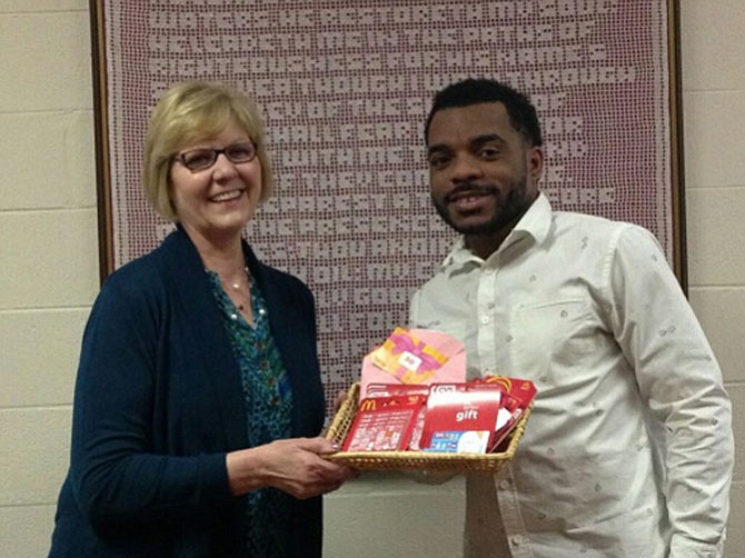 Denise Childers presents gift cards to Mario Wright for the homeless.