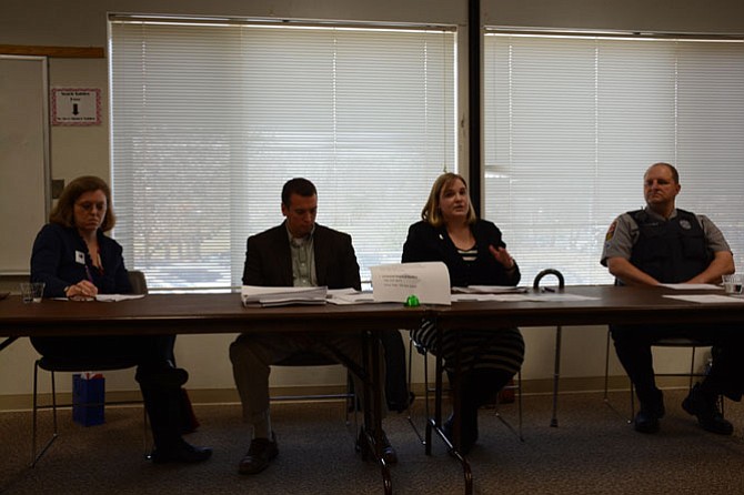 (From left) Moderator Kristin A. Goss, Fairfax County domestic violence coordinator Sandra Bromley, Fairfax County Department of Neighborhood and Community Services prevention manager Jesse Ellis and Fairfax County Police West Springfield precinct crime prevention officer MPO James T. Frey hold a public information forum on firearm safety and suicide and violence prevention at the Pohick Regional Library.
