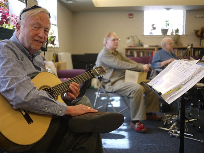 Chuck Vasaly plays with the "Just Play'n Country" group at Lee Senior Center in Arlington.
