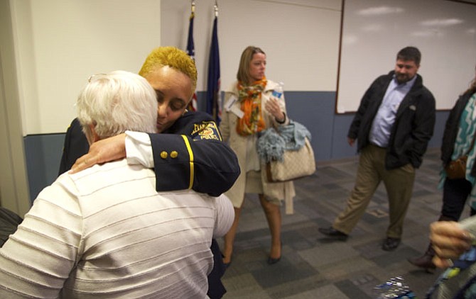 Sgt. Charlette Mitchell and a family guest of the fallen share a moment