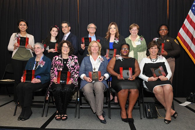 The 2015 Salute to Women Awards honorees include (back row from left): Zauhirah Tipu, Rebecca Nash (daughter of Laurie Meyer), Robert Nash (husband of Laurie Meyer), Ed Singer (husband of Joan Singer), Ashley McNeff Behrens, Ginny Hill-Obranovich and Valarie Wright. Front row from left: Brooksie Koopman, Lorraine Friedman, Cynthia Anderson, LaDonna Sanders and Suzanne Maxey.