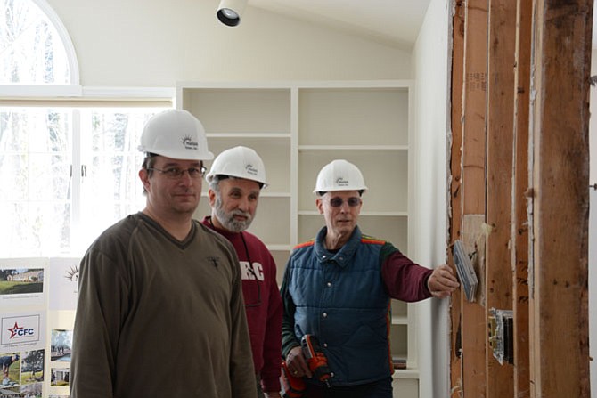 Marian Homes volunteers from Fairfax (from left) — Walter Purdy, Michael Perri and John Germain — work on converting a north Springfield home to make it accessible for people with intellectual disabilities.