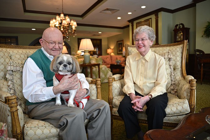 In the lounge at The Woodlands Retirement Community in Fairfax, Col. James McAllan (US Army-Ret) with Riley on his lap and Linda McAllan offered up some thoughts on their senior community living experience. The McAllans were celebrating their Woodlands one-year anniversary that day.
