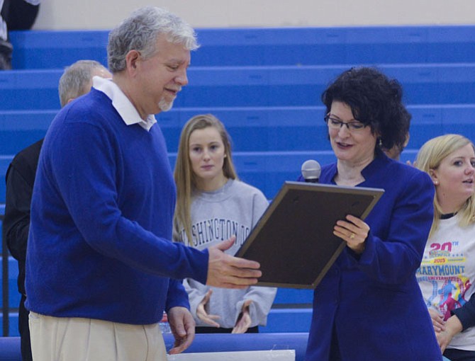 Marymount University President Matthew D. Shank receives a commendation from state Sen. Barbara Favola (Arlington) on behalf of the Commonwealth of Virginia for the school’s 20 years of hosting the Annual Northern Virginia Special Olympics Basketball Invitational Tournament.  