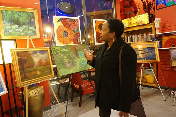 Anita McFadden of Fairfax browses the artwork during the Breath of Spring reception March 19 at Artfully Chocolate.