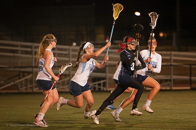 Yorktown players Emma Thurman, Laura Crawford and Kaleigh Day defend against Edison on March 23.