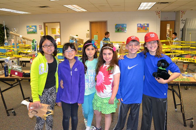 Spring Hill students, Melina Nguyen, Amanda Chung, Maya Pashai, Niki Hoffman, Will Tedesco and Zander Kuebler stand before the student recycled art exhibition.
