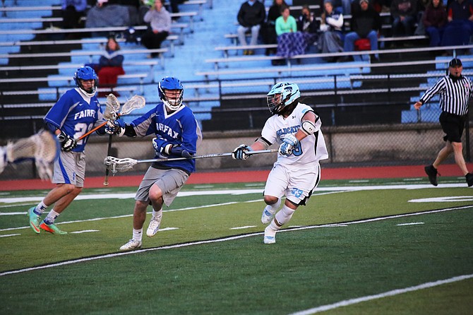 Wildcat defenseman Kainoa O’Connor (33) slows down the Fairfax offense.