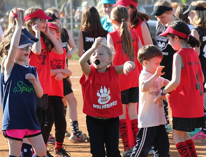 Softball players and children enjoy the opening day festivities.