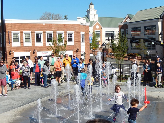 Children enjoy the splash pad in the middle of downtown Fairfax.
