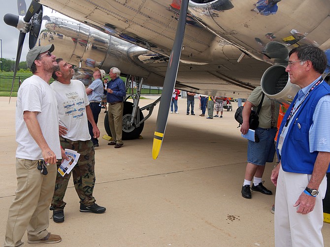 Gene Fischer and Michael Herget (left), both from Alexandria, inspect the C-47 transport plane