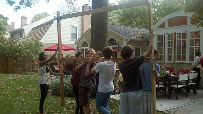 Members of Capital Area Interfaith Friends build a sukkah (shelter) for the Jewish holiday of Sukkot. 
