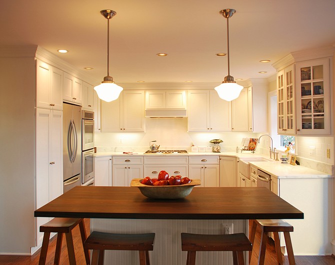 A kitchen with a walnut-topped island accommodates an Arlington couple’s penchant for entertaining.