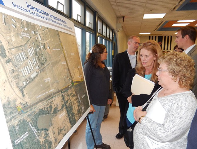 Tami Troscianecki (left) and Sandi Croan look at a diagram of the project area.
