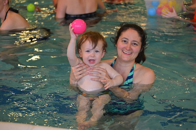 Alexander Miller and mom Jenna are having a ball in the class for the littlest swimmers. Learning to relax in the heated water, the children also practice other motor skills and how to share and take turns. 
