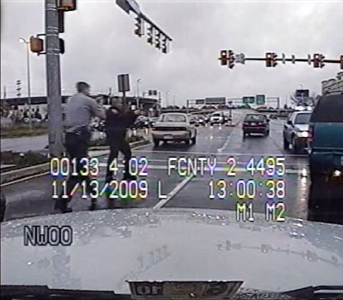 The dashboard-mounted camera in Fairfax County Police officer David Scott Ziants’ cruiser shows Ziants and another officer approaching David Masters’ Chevrolet Blazer with guns drawn.
