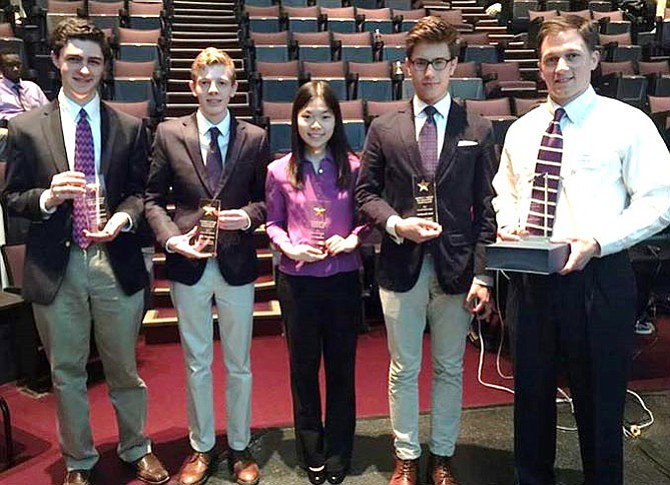 Holding their trophies are (from left) Brendan Aronhime, Kincaid Youman, Alice Wang and Aron Malatinszky with their coach, Joe Clement.