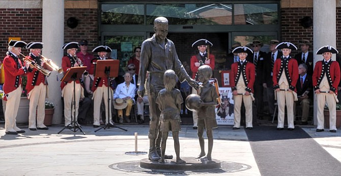  The Historical Trumpets and Flutes of the U.S. Army Old Guard Fife and Drum Corps perform a musical prelude to the Memorial Day ceremony at the Vietnam Veterans Memorial in the Captain Rocky Versace Plaza on Monday morning.
