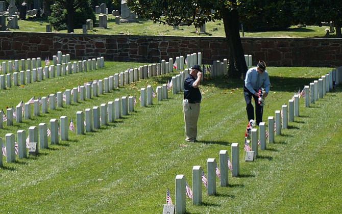 Members of American Legion Post 24 pay tribute to former Legion commanders during the Memorial Day ceremony at Alexandria National Cemetery.