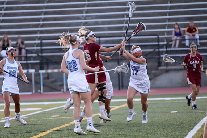 Oakton senior Karlie Cronin attacks the goal while Centreville’s Caroline Kelly (17) defends during Saturday’s 6A North region semifinal contest at Centreville High School. Photo by Jim Henderson

