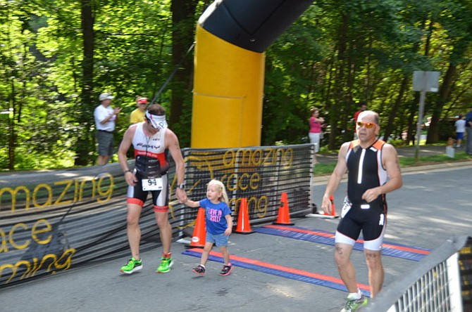 Sterling resident Ryan Albrecht crossed the finish line with his daughter. The Reston Sprint Triathlon event included 15 miles of swimming, biking and running.
