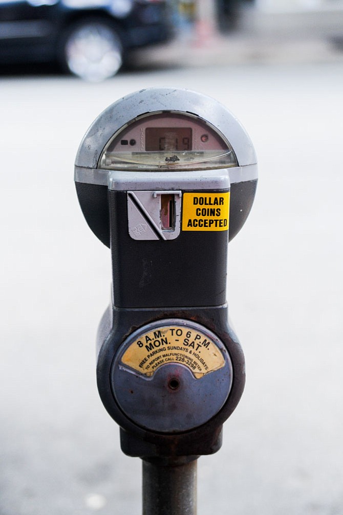 Parking meter in Clarendon with current parking hours listed. 