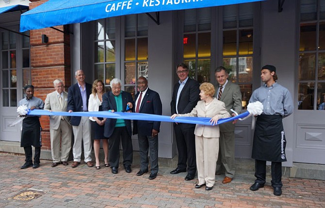 Antonio Carluccio, fifth from left, prepares to cut the ribbon June 2 at Carluccio’s, a new Italian restaurant and market located at 100 King St. The Old Town location marks the first U.S. location for the popular European eatery.
