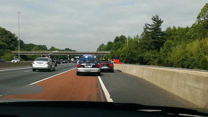 A Virginia State Trooper pulls over a driver that sped past a parked police car with its emergency lights flashing.