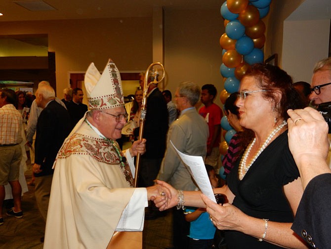 Bishop Paul S. Loverde greets a Good Shepherd parishioner after the 50th anniversary Jubilee Mass on May 30.