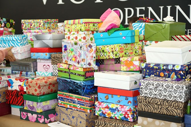 Volunteers decorate and fill shoeboxes with personal care items to be distributed to local area charities and nonprofit organizations during Do More 24 on Thursday, June 4 at Tysons Corner Center.

