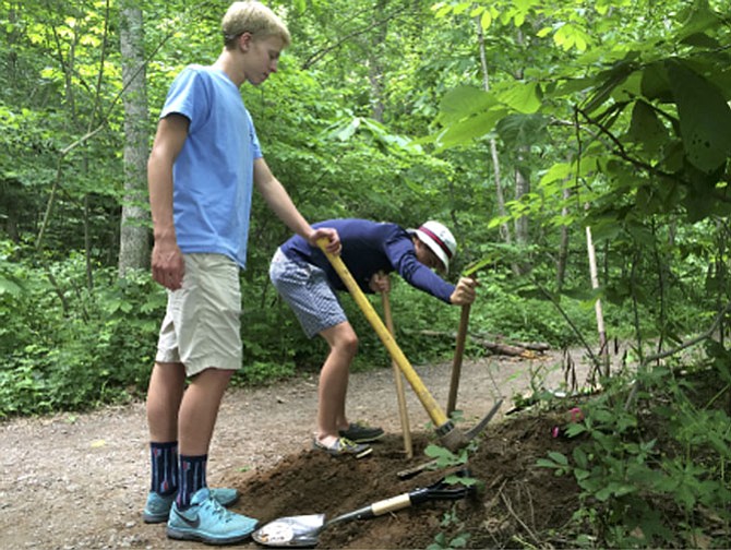 Jared Lampal (left) and Jake Wadle work on the construction of one of three fishing line recyclers as part of Alex Brunner’s Eagle Scout Project at Riverbend Park. 
