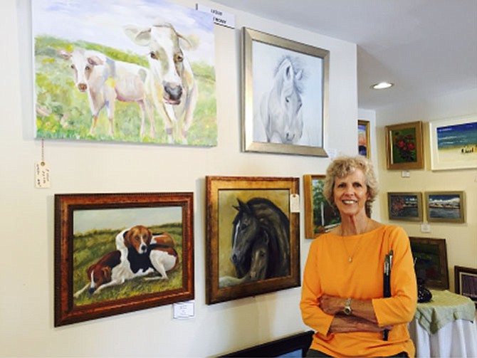 Leslie Anthony  with her menagerie of animal portraits at Artists at the Green in Great Falls.
