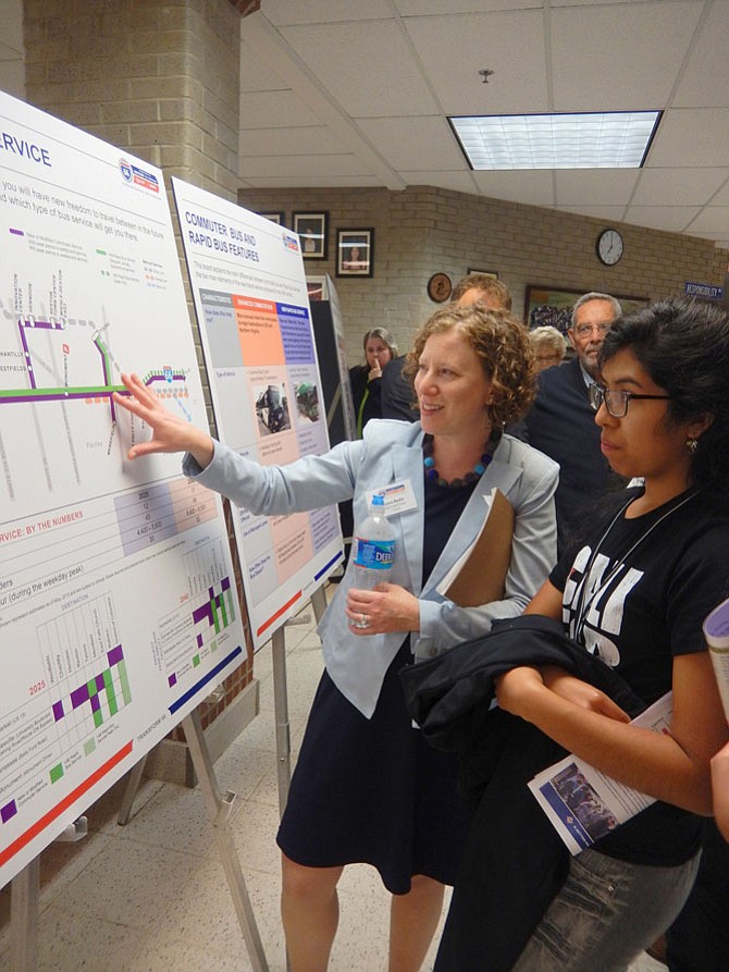 Lora Byala, with the consultant team, explains proposed I-66 bus-service options with area residents.