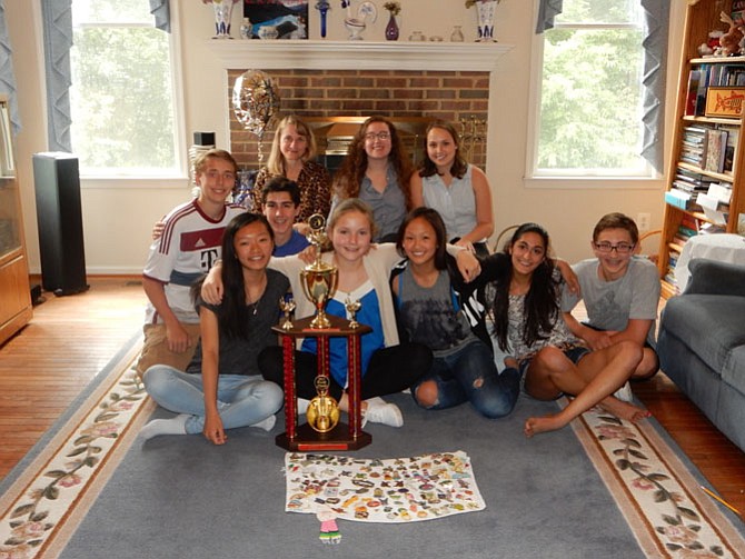 A photo of Team One with their third place trophy and pin towel. Featuring coaches Emily Marko, Olivia Peterkin and Julia Estrada. Team members, from left: Ryan Jones, Ethan Waple, Wen Ip, Charlotte Peterkin, Charlotte Cai, Maya Nakhre, Noah Ginsburg
