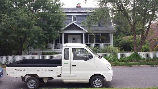 Jim Egenrieder’s electric truck and a view of his home’s solar panels. 