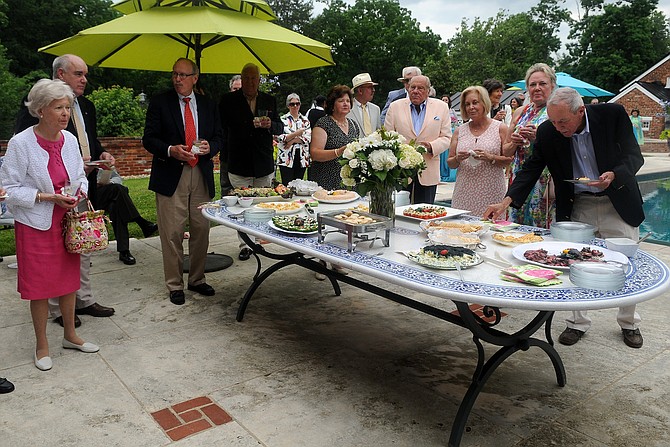Guests enjoy a light buffet outside the pool house.
