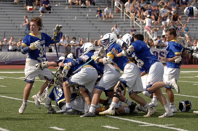 Members of the Robinson boys' lacrosse team celebrate their victory over Chantilly in the 6A state championship game on June 13 at Lake Braddock Secondary School.